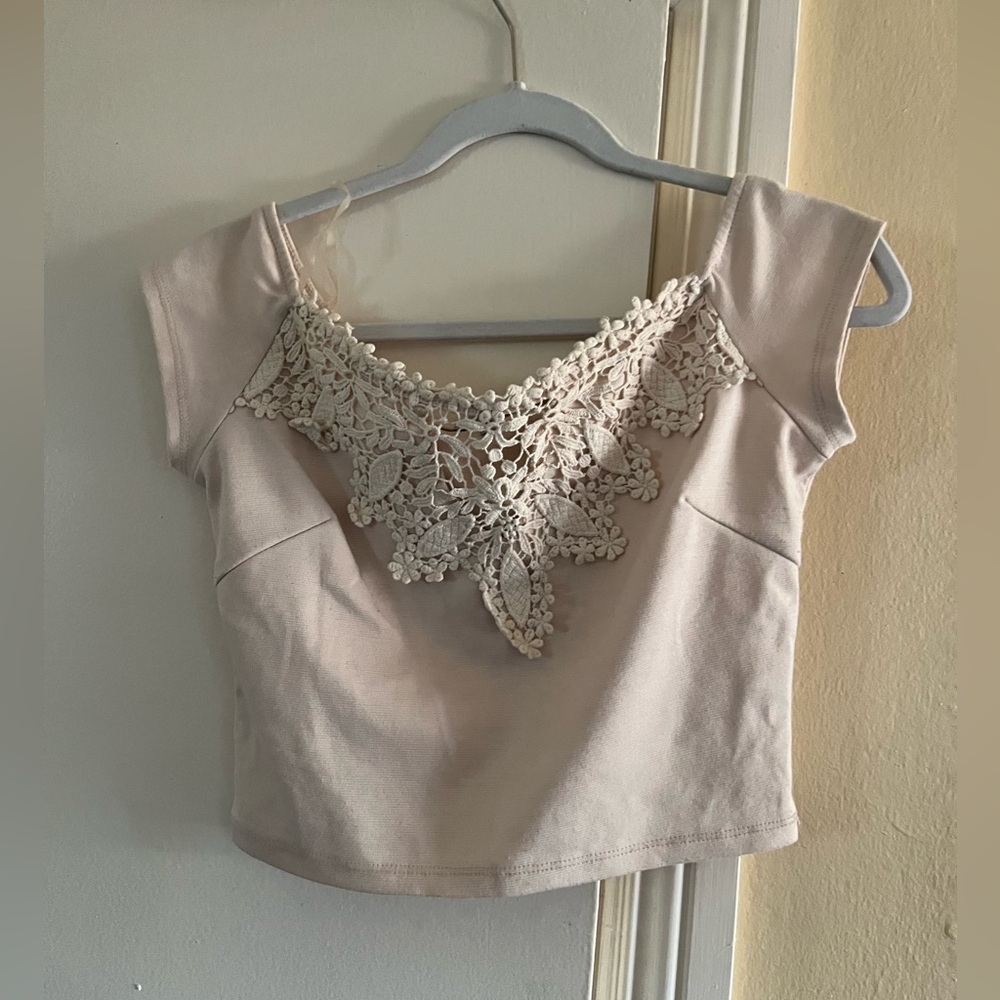 Crop top with knitting design on front.